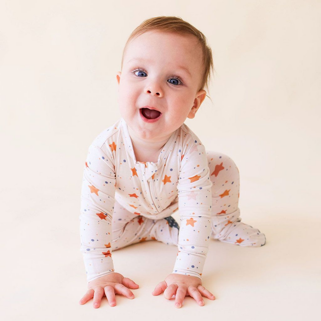 cute baby wearing star-pattern footie pajamas